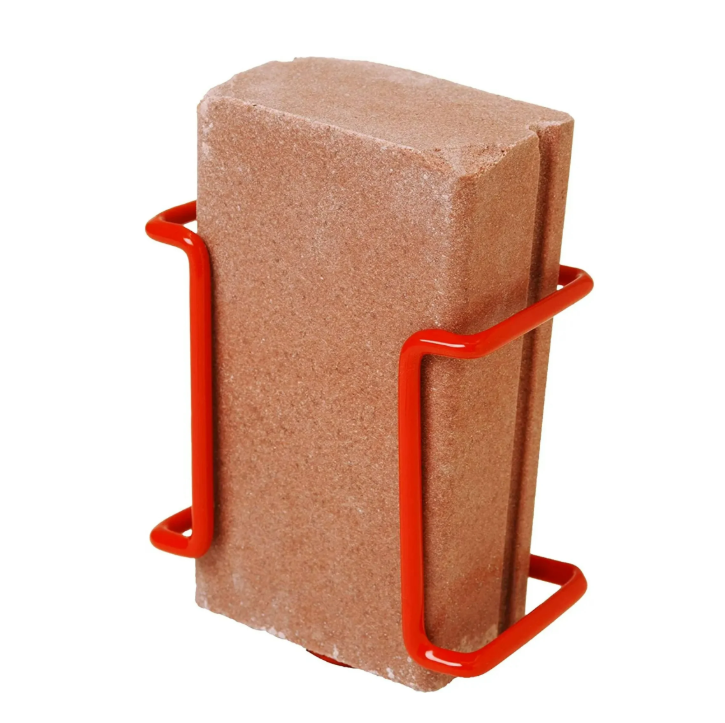 Red metal stand holding a brown block on a white background