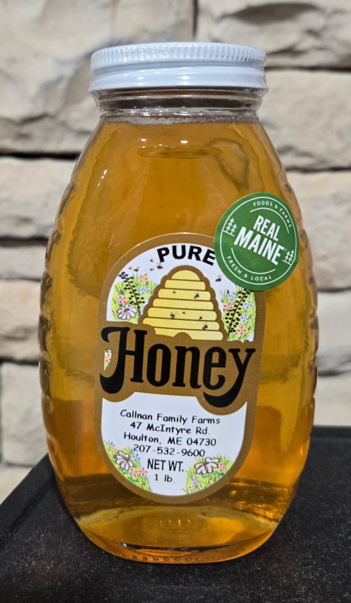Bottle of honey with a label on a white background