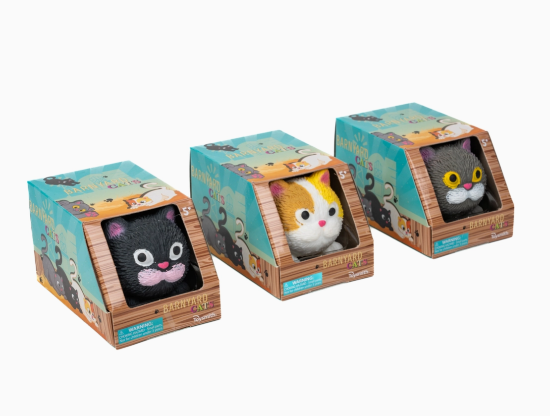 Three small plush toys in decorative boxes on a white background
