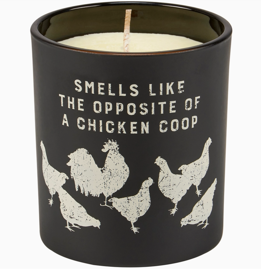 Black candle with chicken coop design and text on a white background