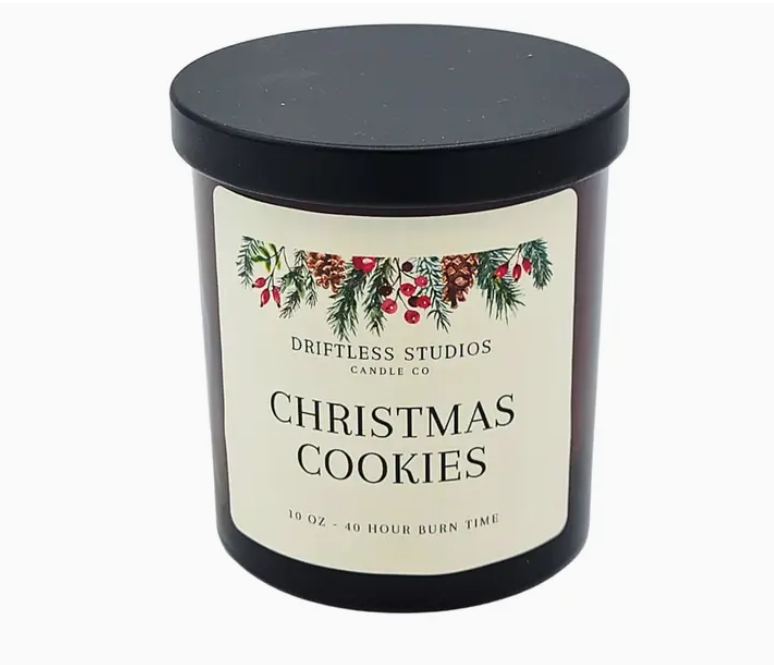 Candle with 'Christmas Cookies' label and Driftless Studios Candle Co branding on a white background