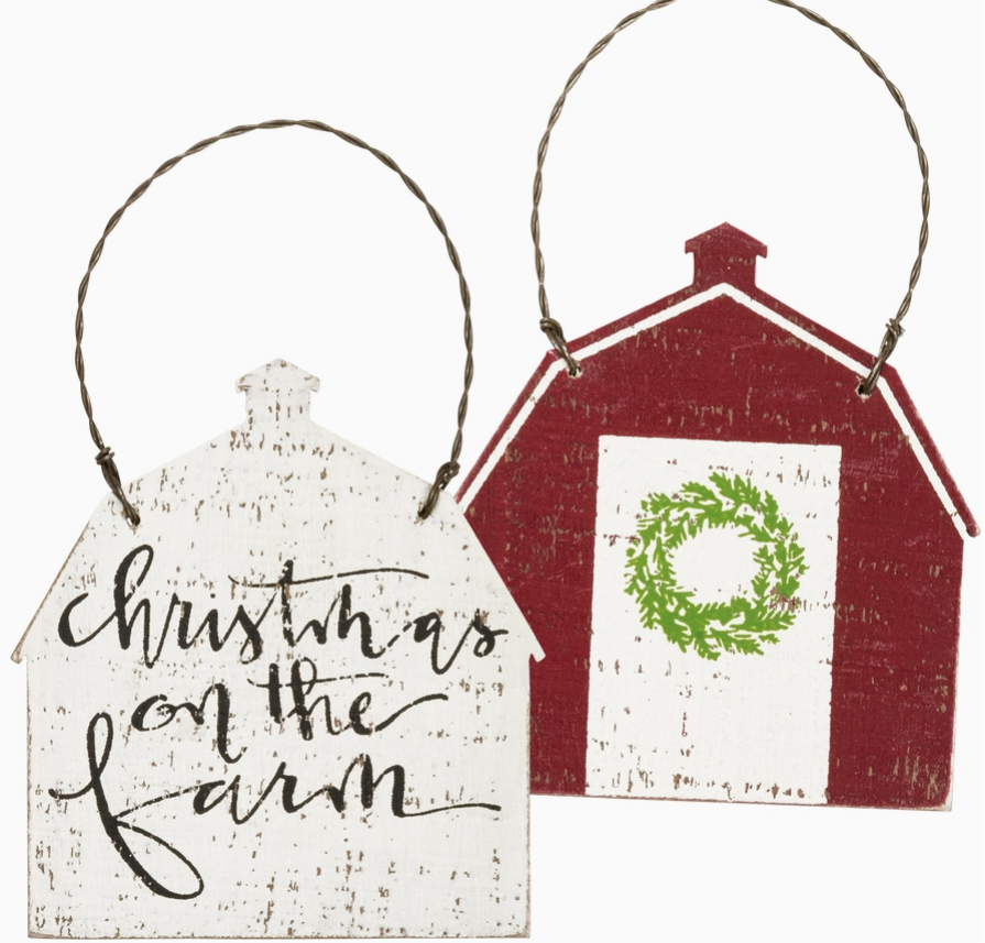Two Christmas-themed house-shaped signs with 'Christmas on the Farm' text and a red barn design.