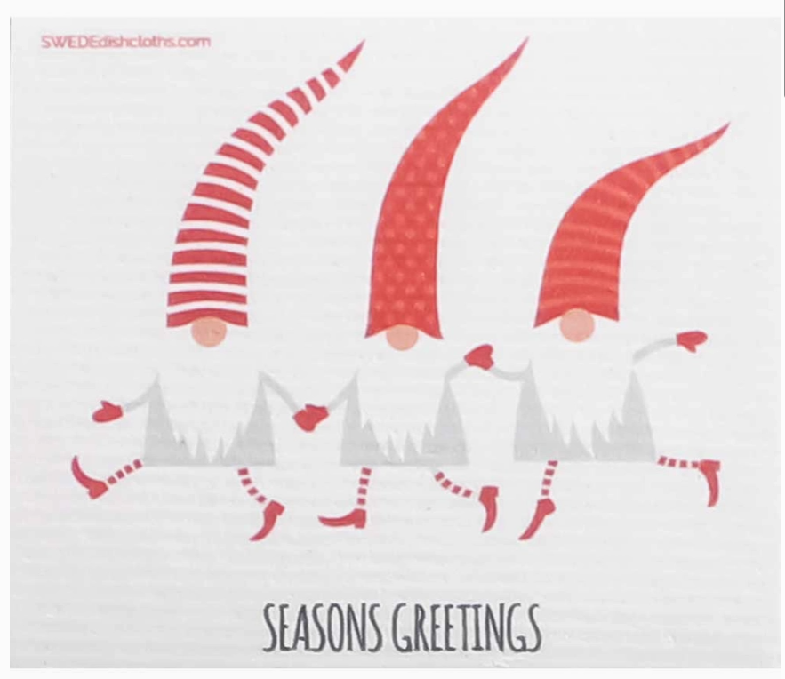 A Swedish dishcloth with three dancing elves and the words "seasons greetings" on a white background.