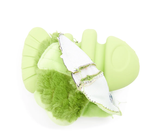 Green fish-shaped dog toy with the plush layer torn back to reveal rubber core, on a white background