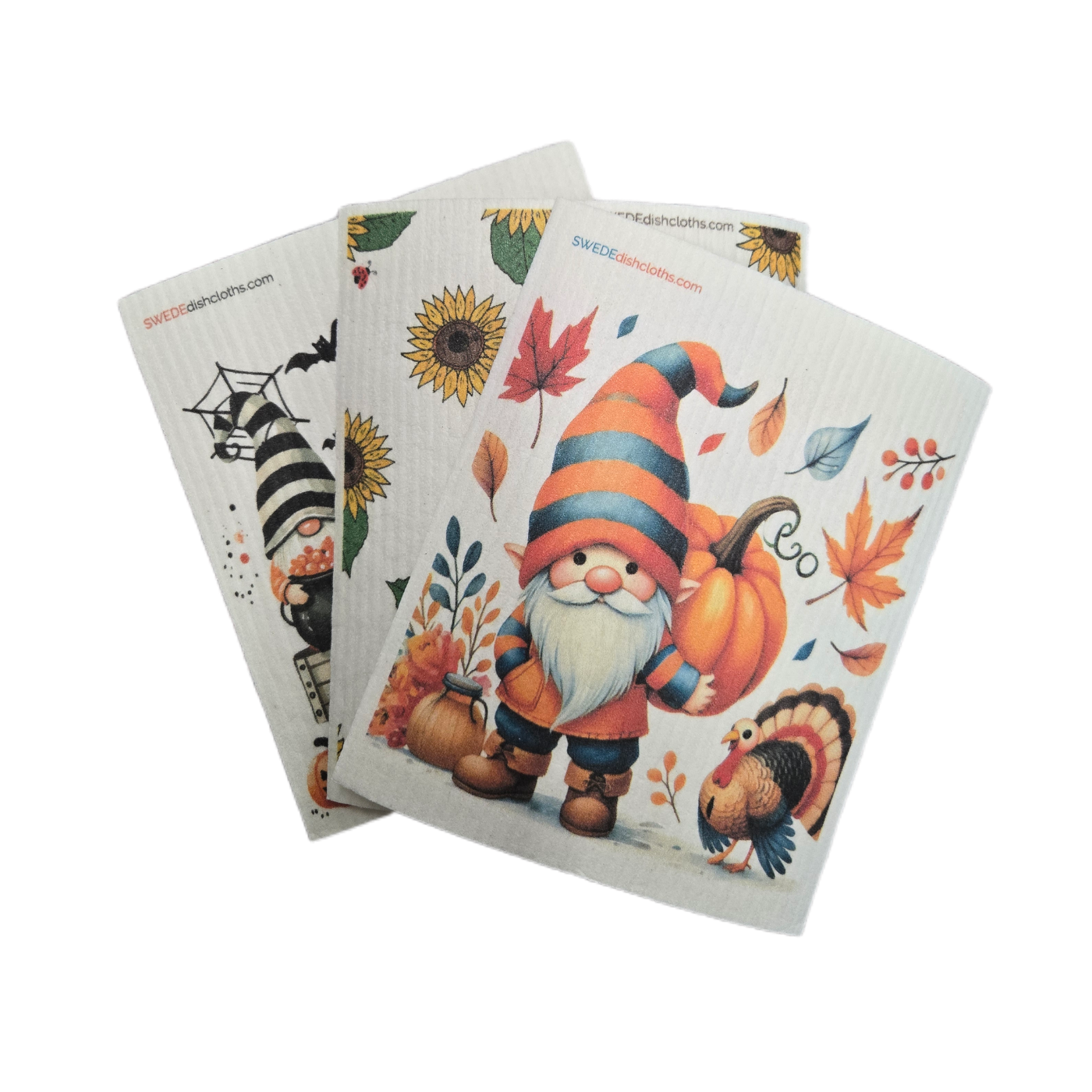 Set of three decorative kitchen towels with autumn-themed designs on a white background.