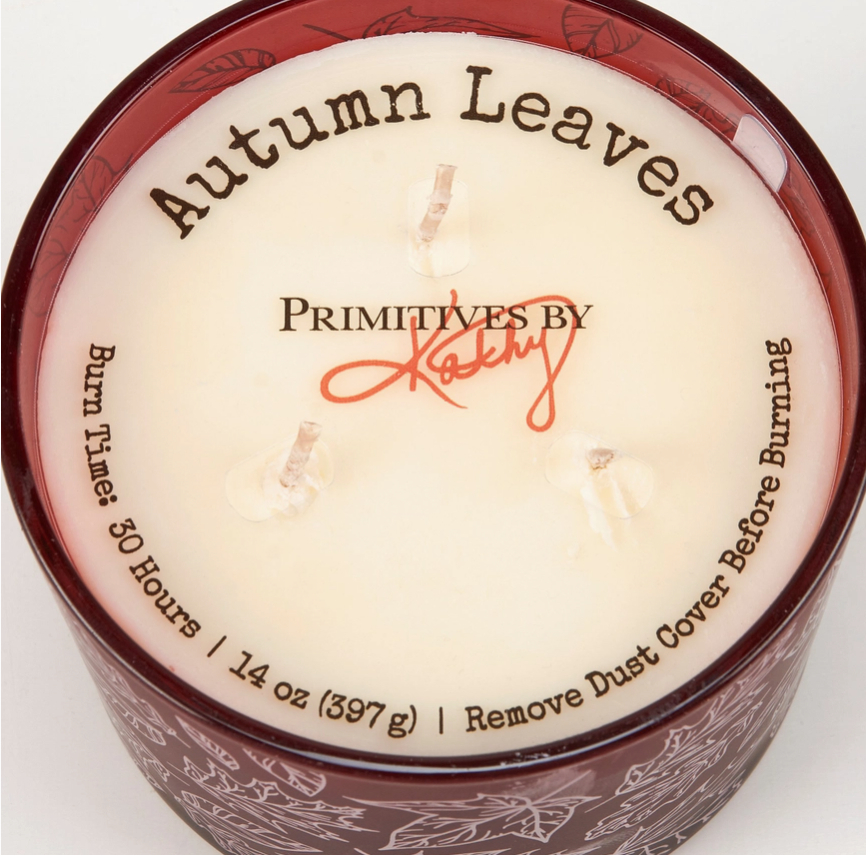 Candle labeled 'Autumn Leaves' by Primitives by Kathy on a white background