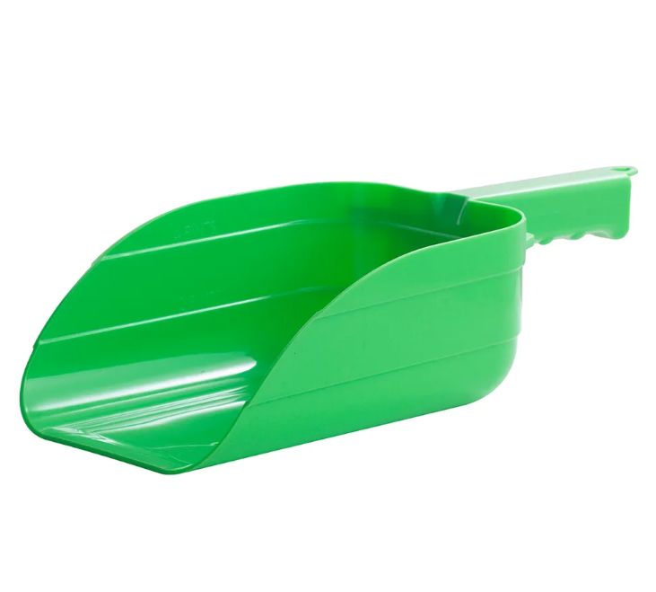 Green plastic scoop on a white background