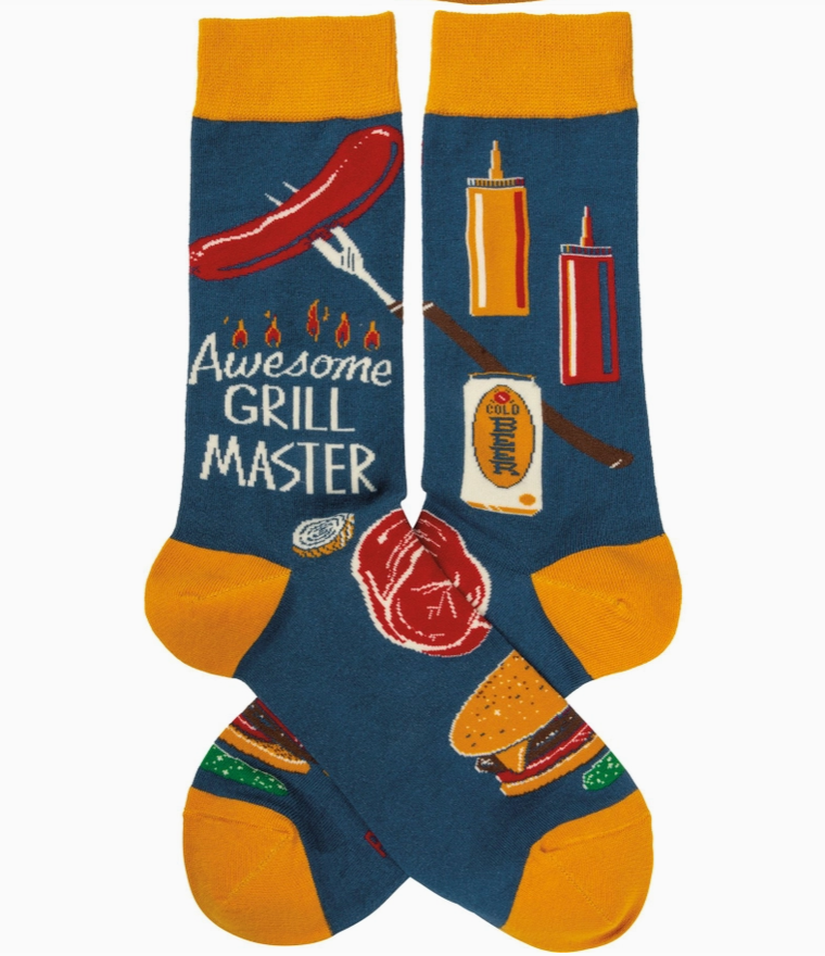 Pair of blue and orange novelty socks featuring grill-themed design and phrase "awesome grill master," on a white background.