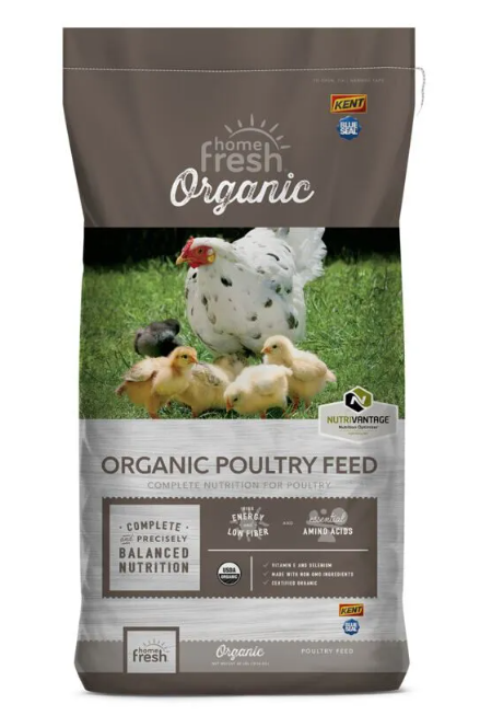 Bag of organic poultry feed with chickens on a grassy background