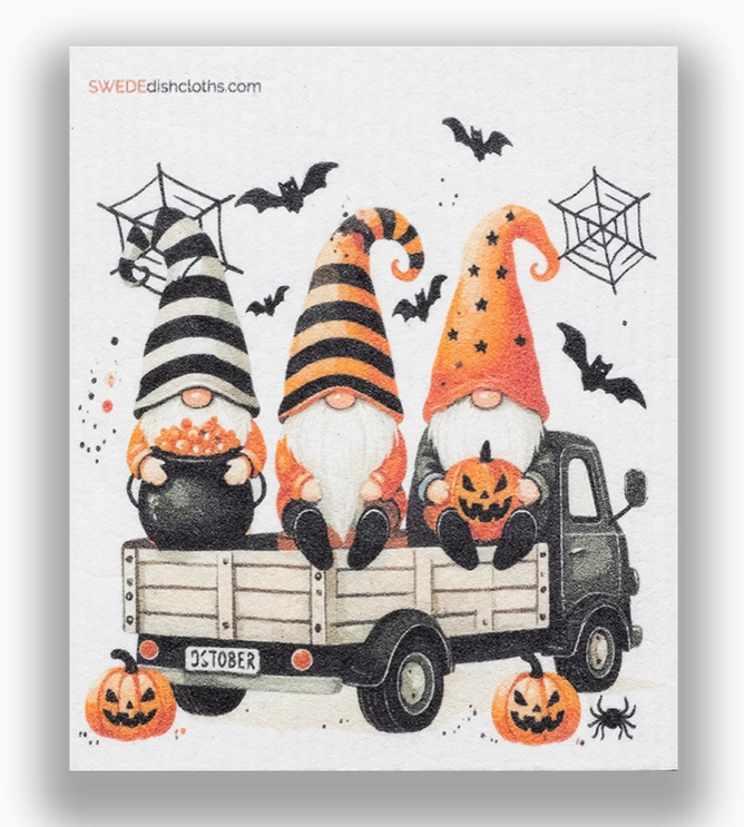 Halloween-themed design with gnomes in a truck, pumpkins, and bats on a white background.