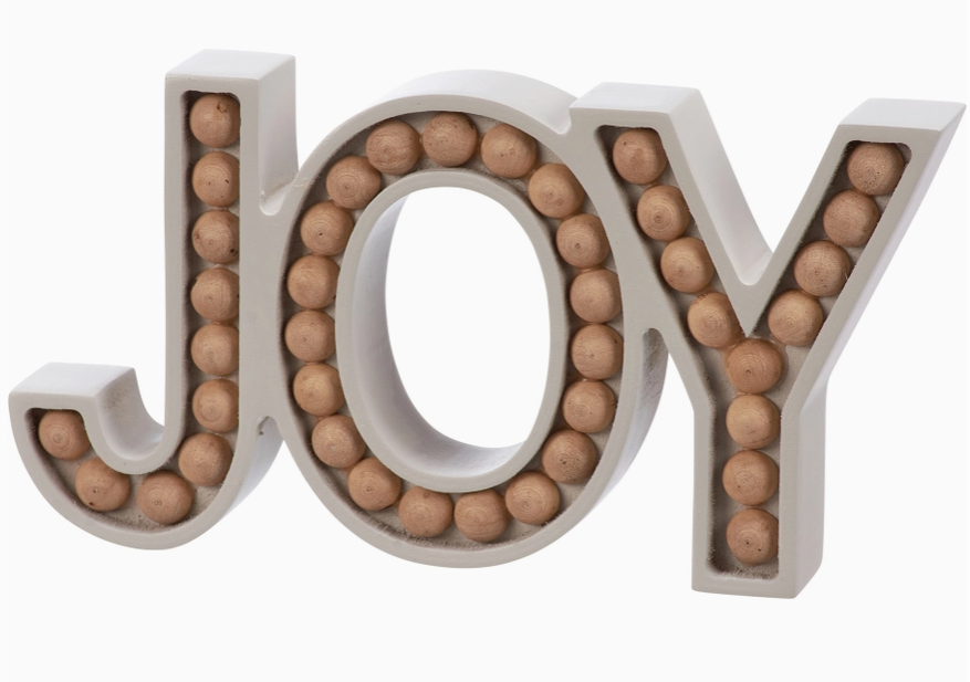 Decorative letters spelling 'JOY' filled with wooden beads on a white background