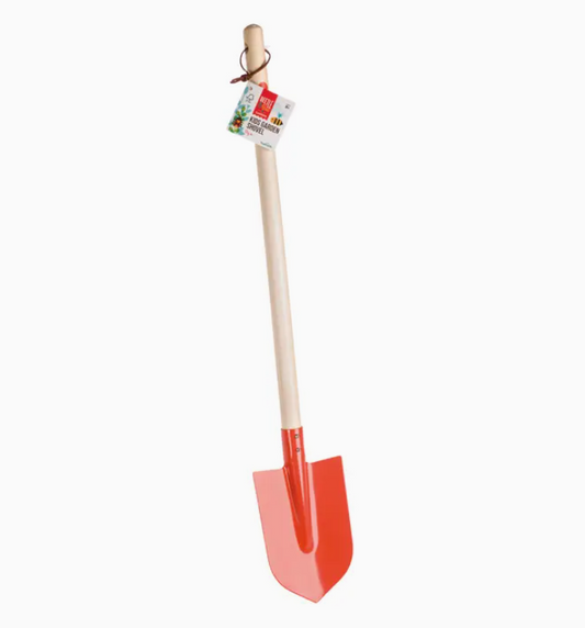 Red children's shovel with a wooden handle on a white background