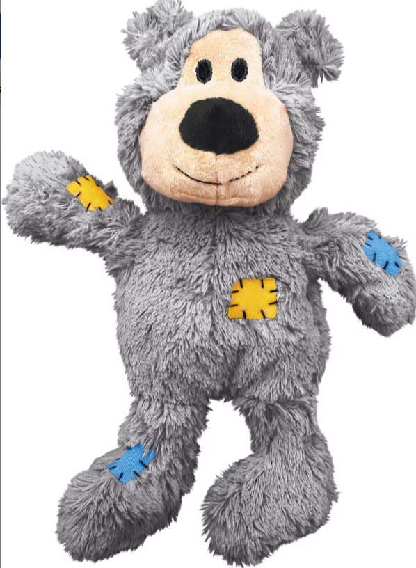 Gray plush bear toy with colorful patches on a white background