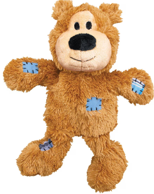 Brown teddy bear plush toy with blue patches on a white background