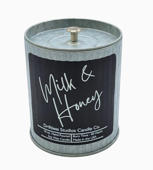 Milk & Honey scented candle in a tin container with lid on a white background.