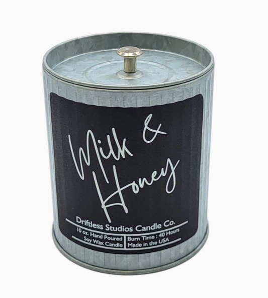 Milk & Honey scented candle in a tin container with lid on a white background.