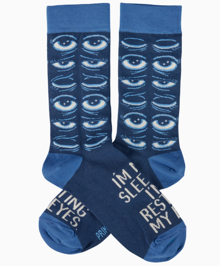 Pair of blue socks with eye pattern and text on a white background