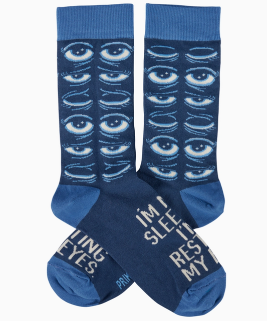 Pair of blue socks with eye pattern and text on a white background