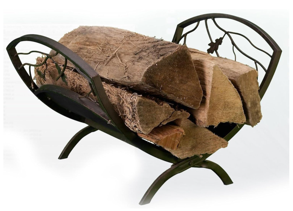 Wooden logs in a decorative metal firewood holder on a white background