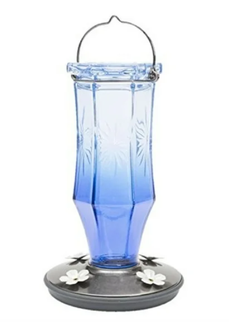Blue glass hummingbird feeder on a white background