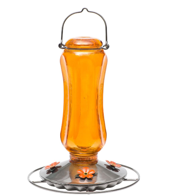 Orange glass oriole feeder with metal base on a white background
