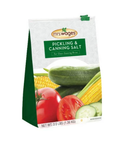 Bag of Mrs. Wages pickling and canning salt with vegetables on a white background