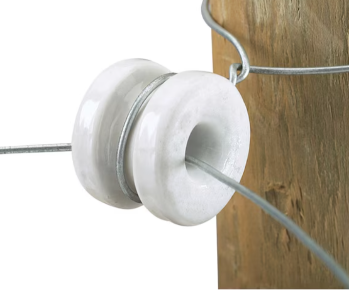 Close-up of a white insulator on a wooden background