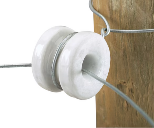 Close-up of a white insulator on a wooden background