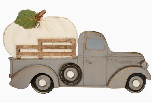 Decorative model of a truck with a pumpkin on a white background