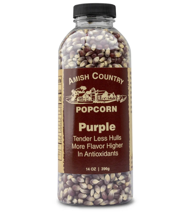 Bottle of Amish Country Popcorn with purple kernels on a white background