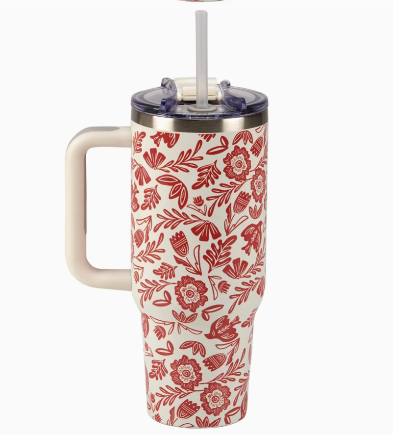 Floral-patterned tumbler with handle on a white background