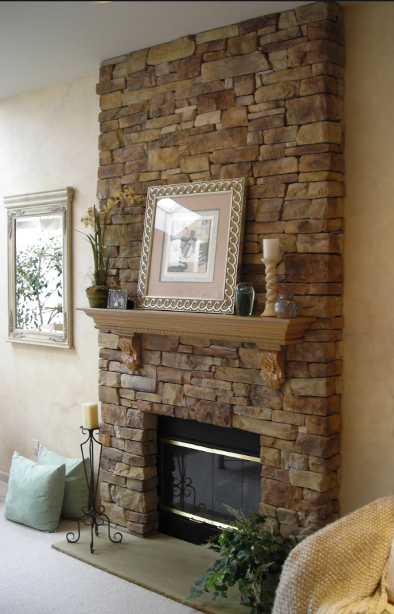 Stone fireplace with decorative items in a living room setting