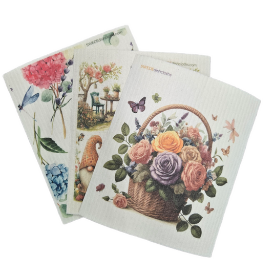 Set of three decorative dishcloths with floral and garden-themed designs on a white background.
