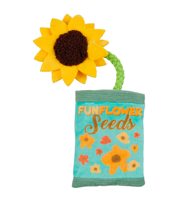 Toy resembling a bag of sunflower seeds with a sunflower on top against a white background