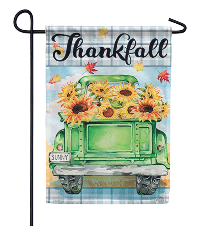 Decorative garden flag with a green truck, sunflowers, and 'Thankfall' text on a plaid background.