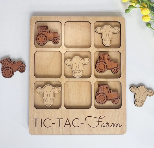 Wooden tic-tac-toe game with farm animal and vehicle shapes on a white background.
