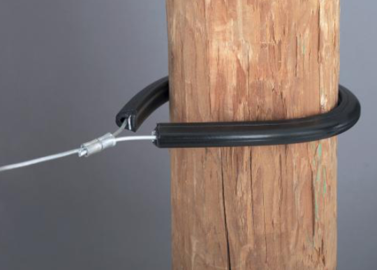 Tubular Corner & end post insulator around a wood post on a gray background.