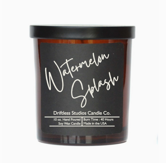 Watermelon scented candle in an amber glass jar with black metal lid, on a white background.