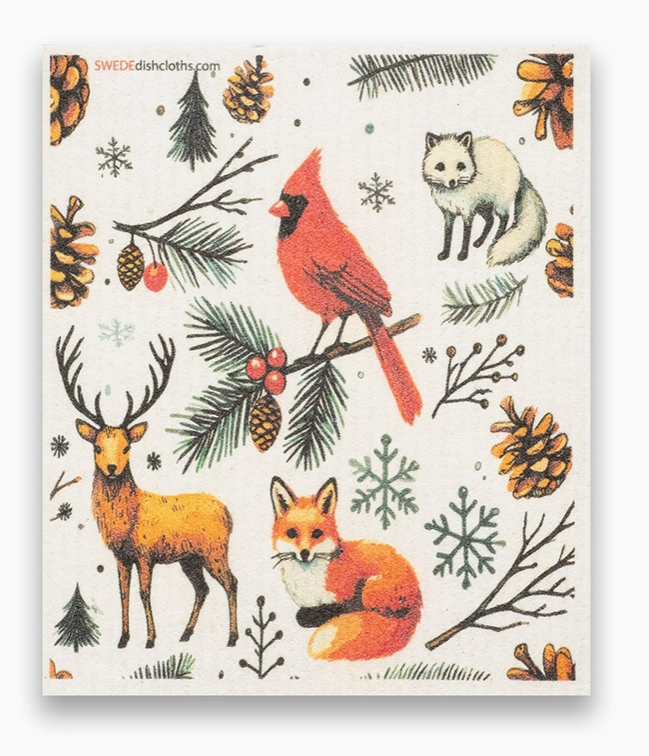Swedish dishcloth with winter-themed design featuring animals and nature elements on a white background.