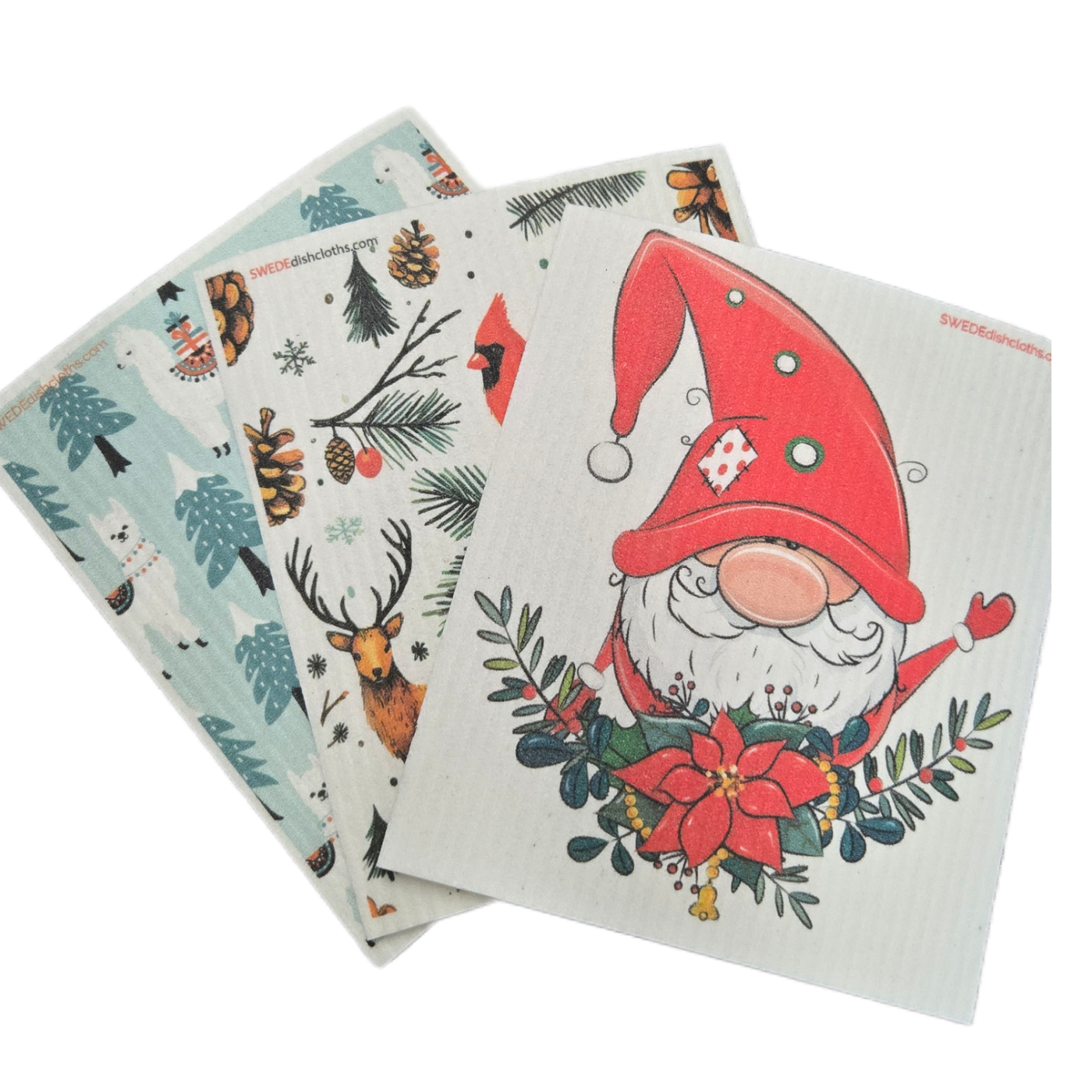 Three dishcloths with winter holiday designs on a white background.