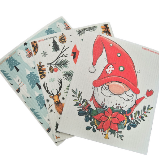 Three dishcloths with winter holiday designs on a white background.