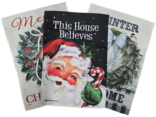 Three Christmas-themed flags with Santa Claus and winter scenery.