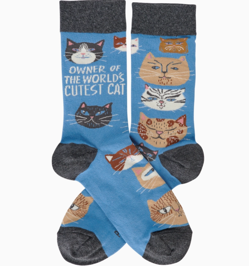 Pair of socks with cat designs and text 'Owner of the World's Cutest Cat' on a blue background.